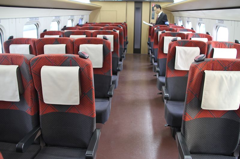 Standard-class carriages feature vermillion and check-patterned seats.