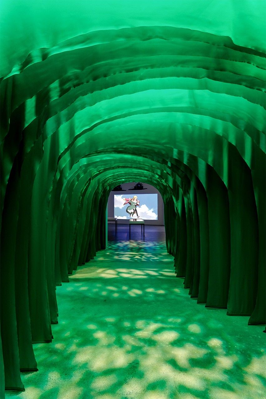 Visitors enter the Miyazaki exhibit through a Totoro-inspired Tree Tunnel. (Photo by Joshua White/© Academy Museum Foundation)