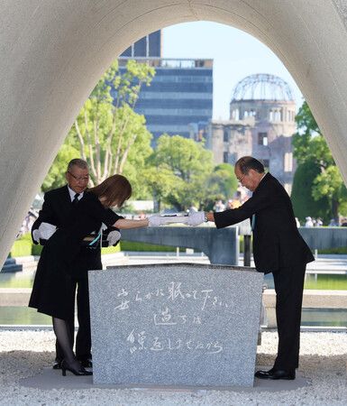 廣島市長松井一實(右)與罹難者家屬代表,在和平紀念儀式中將原爆死難者名冊安放於慰靈碑內。攝於8月6日上午,廣島市中區和平紀念公園