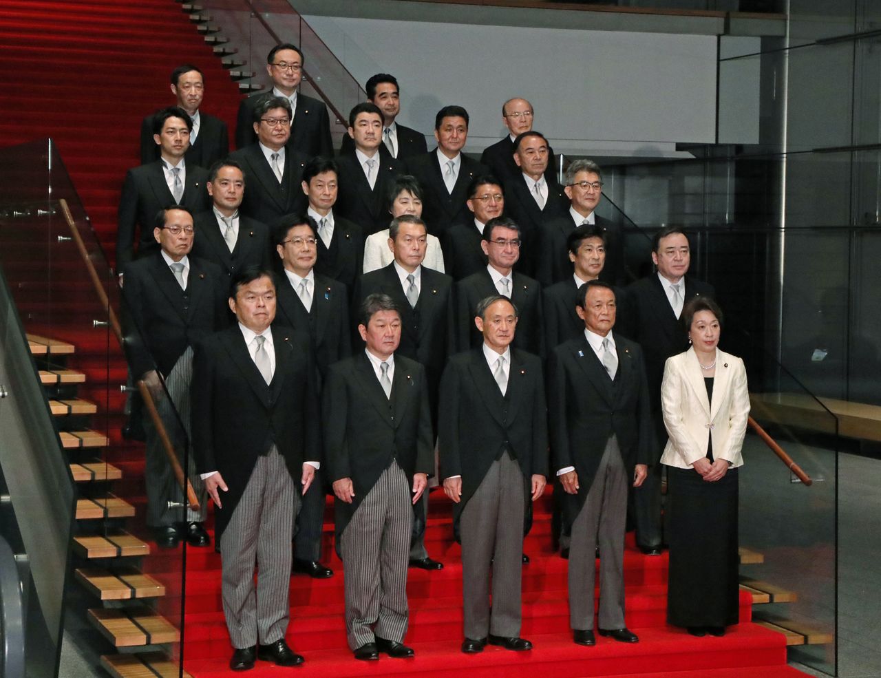 رئيس الوزراء سوغا يوشيهيدي في صدارة المقدمة، وسط أعضاء حكومته الجديدة في 16 سبتمبر/ أيلول في مقر عمل وإقامة رئيس وزراء اليابان (الصورة من جيجي برس)