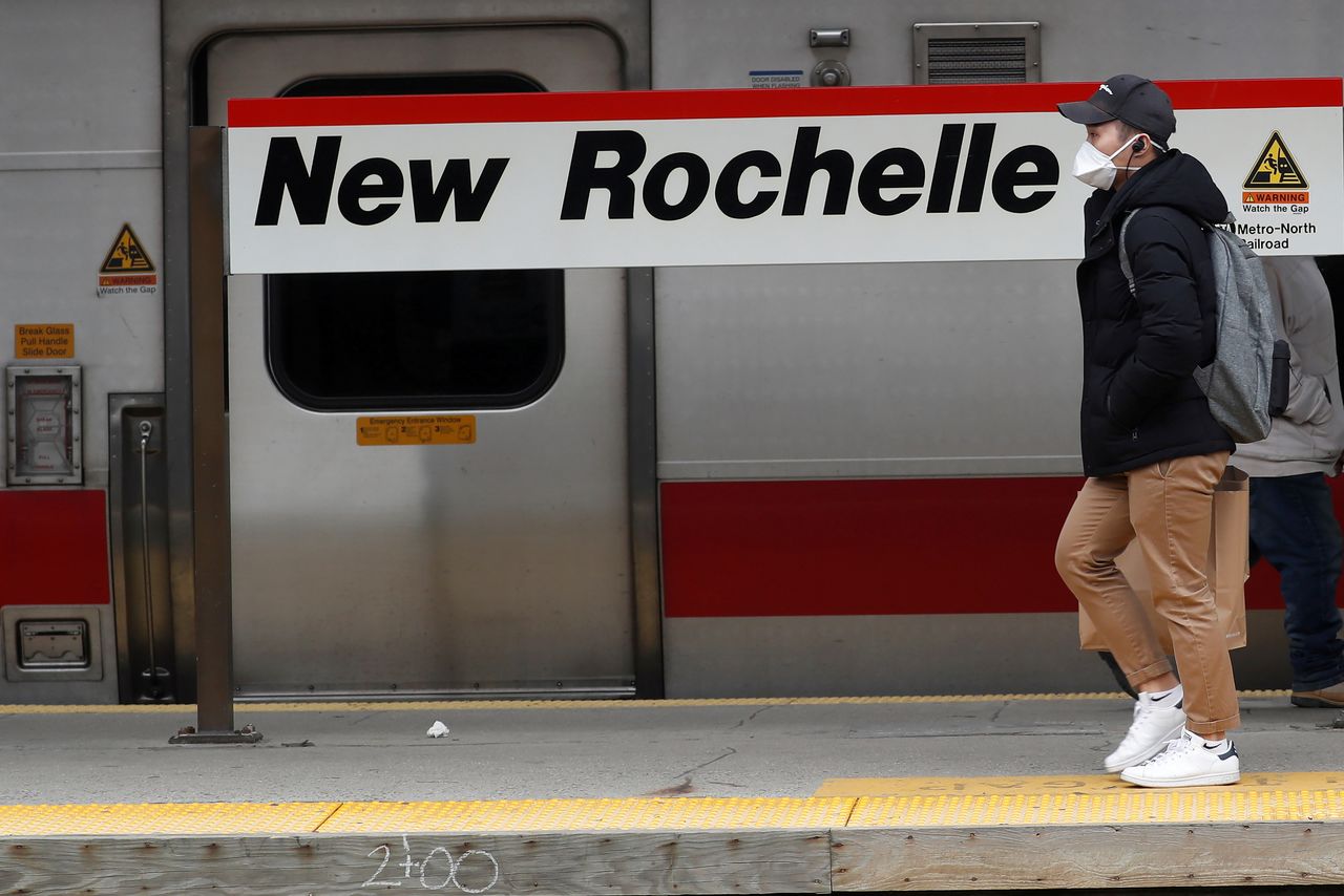 رجل يضع كمامة يسير على رصيف محطة قطارات في نيو روتشيل بنيويورك في صورة من أرشيف رويترز.