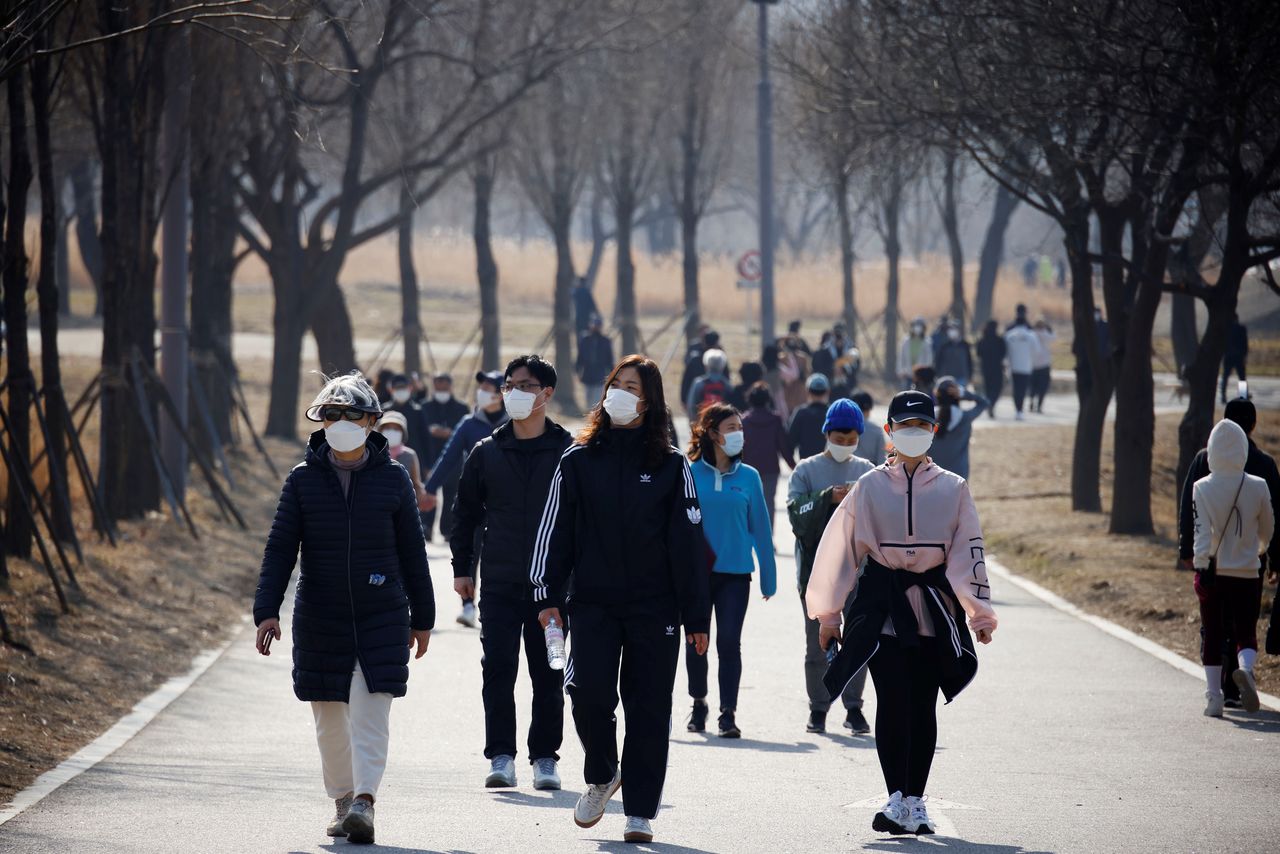 أشخاص يضعون كمامات على وجوههم في كوريا الجنوبية يوم 21 فبراير شباط 2021 - رويترز