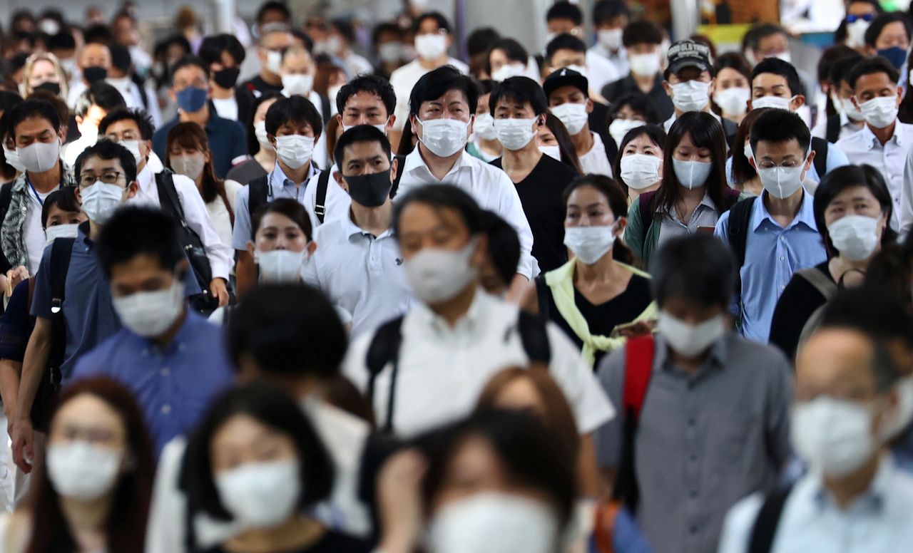 أشخاص يضعون كمامات للوقاية من فيروس كورونا في طوكيو يوم 28 يوليو تموز 2021. تصوير: كيم كيونج هون - رويترز.