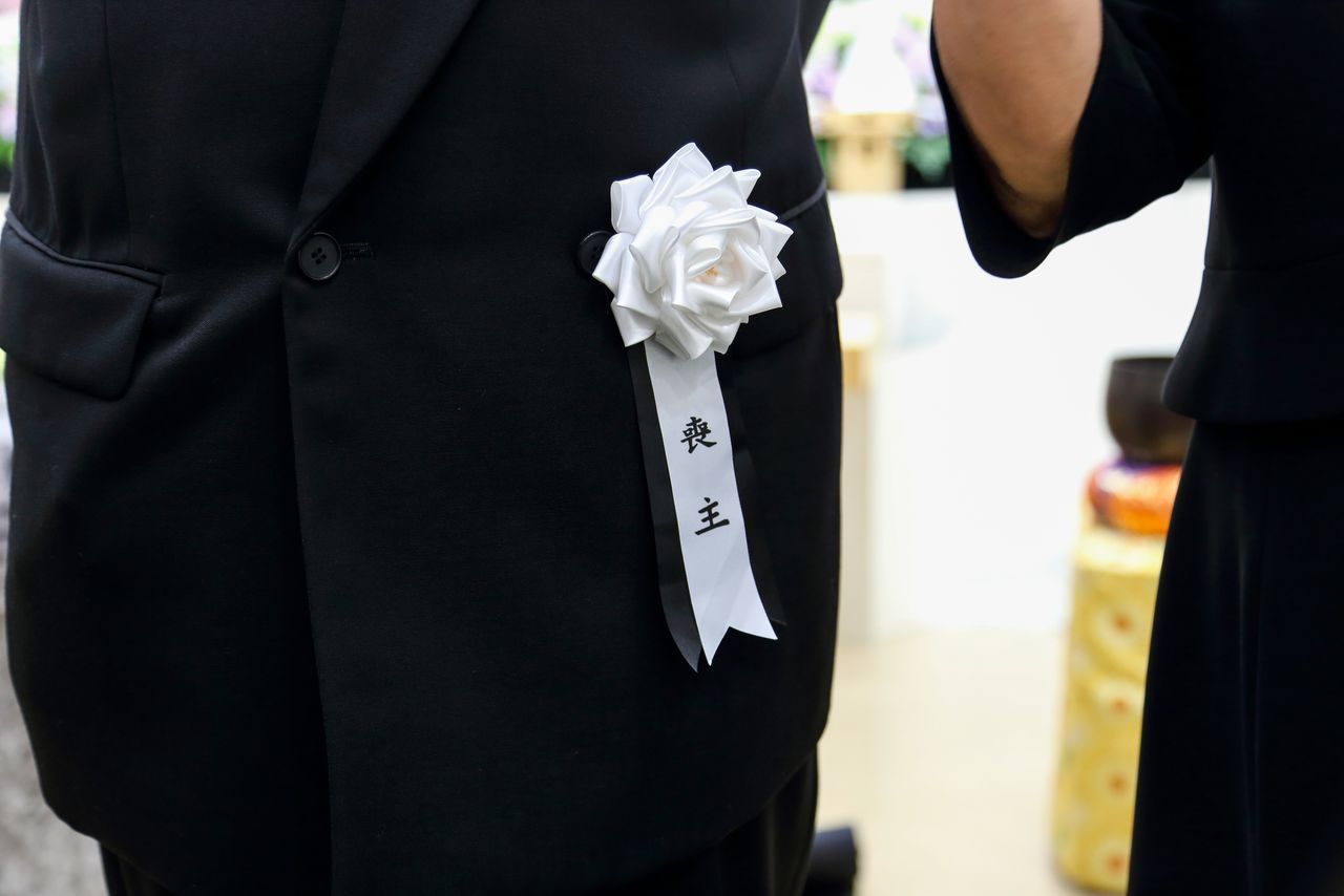 即便与逝者家属素未谋面,凭臂上的黑纱或胸前的黑色缎带等标志物亦可辨认(图片:PIXTA)