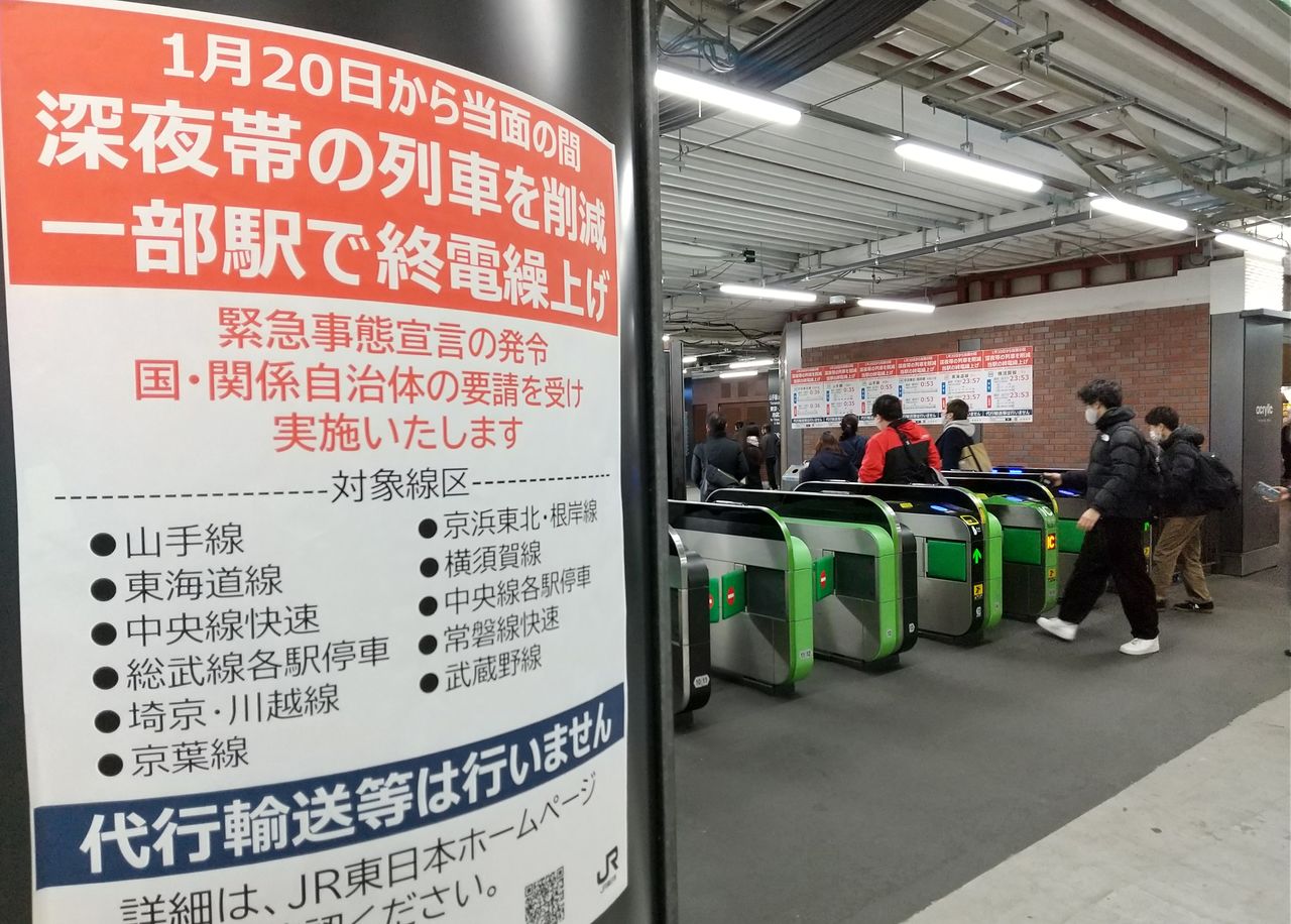 JR新桥站检票口附近张贴的末班车提前收车告示，2021年1月20日晚，东京都港区（时事社）