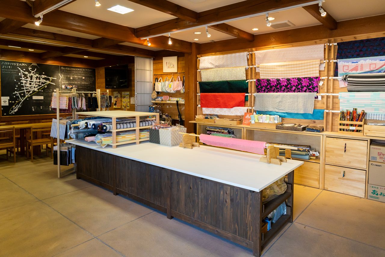 The Center offers a space where visitors can inspect fabrics or try their hand at making a fabric-covered button.