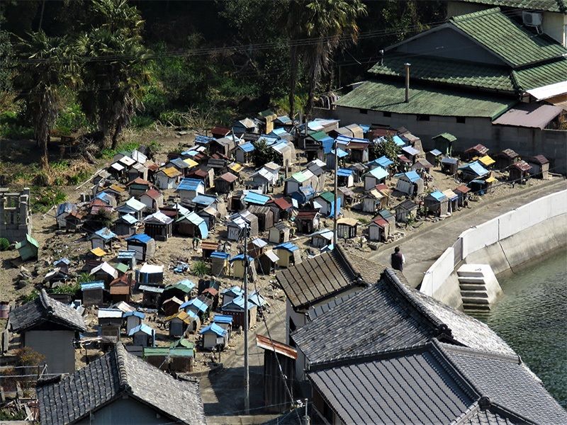 Small, house-like graves look out over the water.