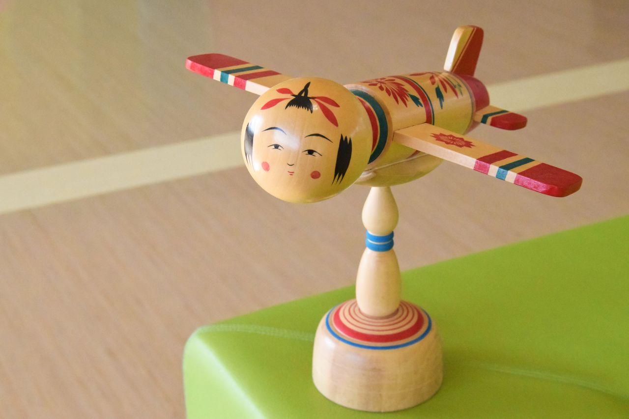 An airplane-shaped kokeshi on display at the Miyagi Prefectural Office.