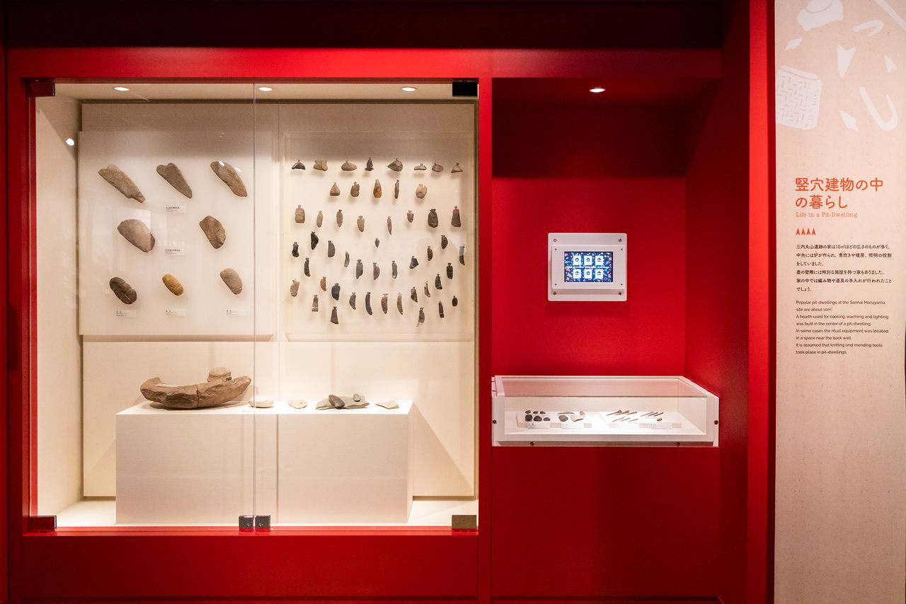 Knife blades, needles, and other stone tools on display.