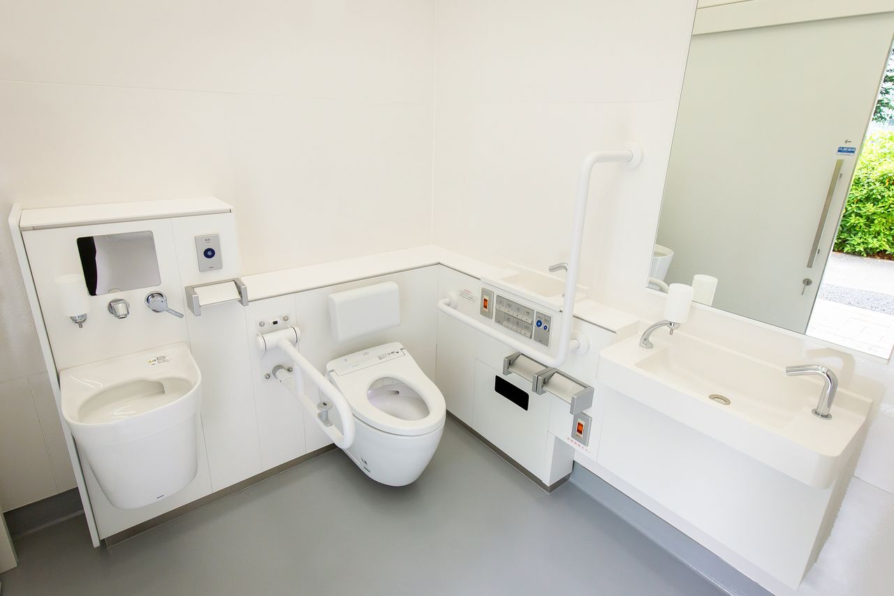 Amenities inside include a bidet toilet with heated seat, an ostomate toilet, and a wall-mounted child seat.