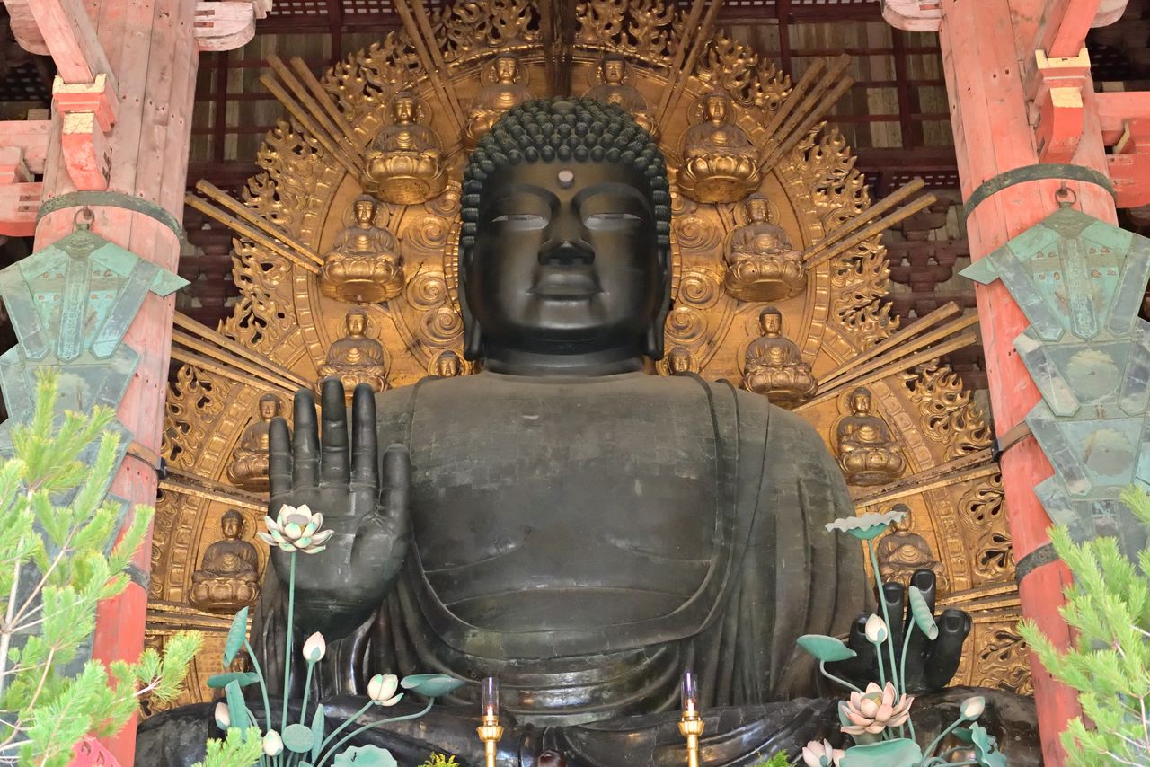 The statue depicts the Roshana Buddha in seated position.
