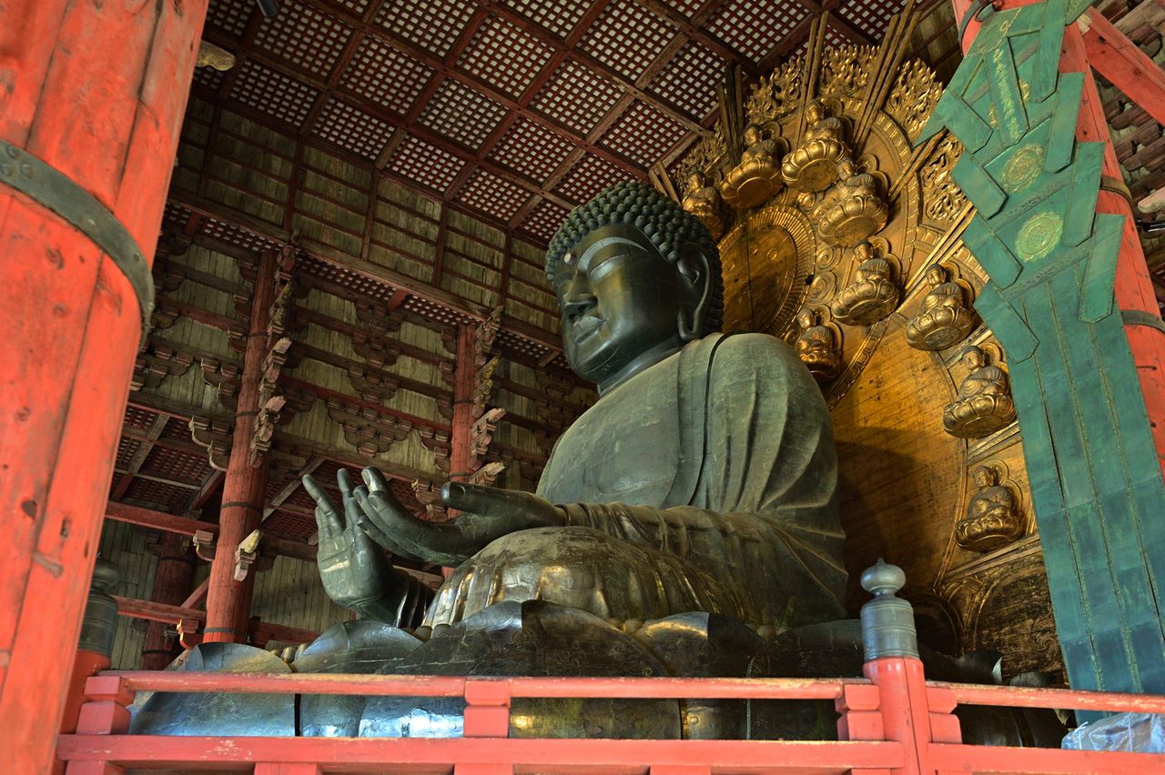 The Buddha has been damaged by fire and restored several times during its life, as manifested by the differing tints of bronze on the head and chest.