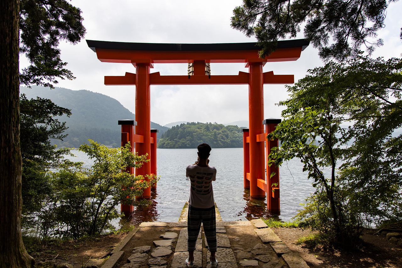 The partially submerged Gate of Peace at Hakone Shrine is a popular photo spot.