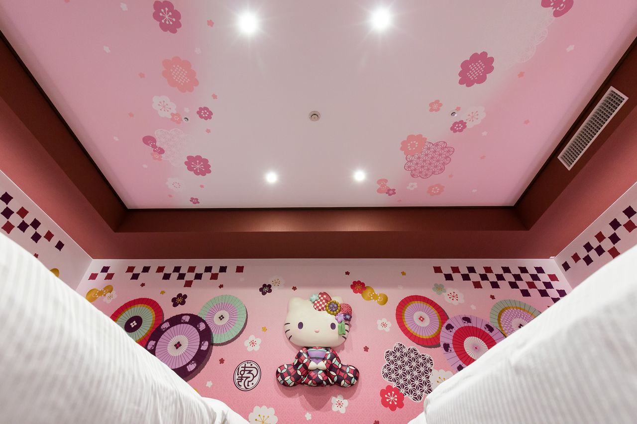 Even the ceiling is pink and embellished with chic traditional motifs to match the rest of the room.