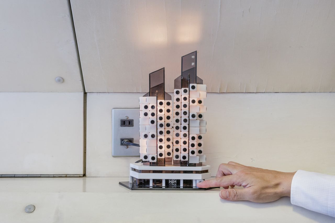 A model of the Nakagin Capsule Tower on display in a room owned by Sekine Takayuki within the building. Designed by Kurokawa Kishō and built in 1972, the tower is one of the few structures from the Metabolism movement that remains standing in 2021. Photographed on July 23, 2016. 