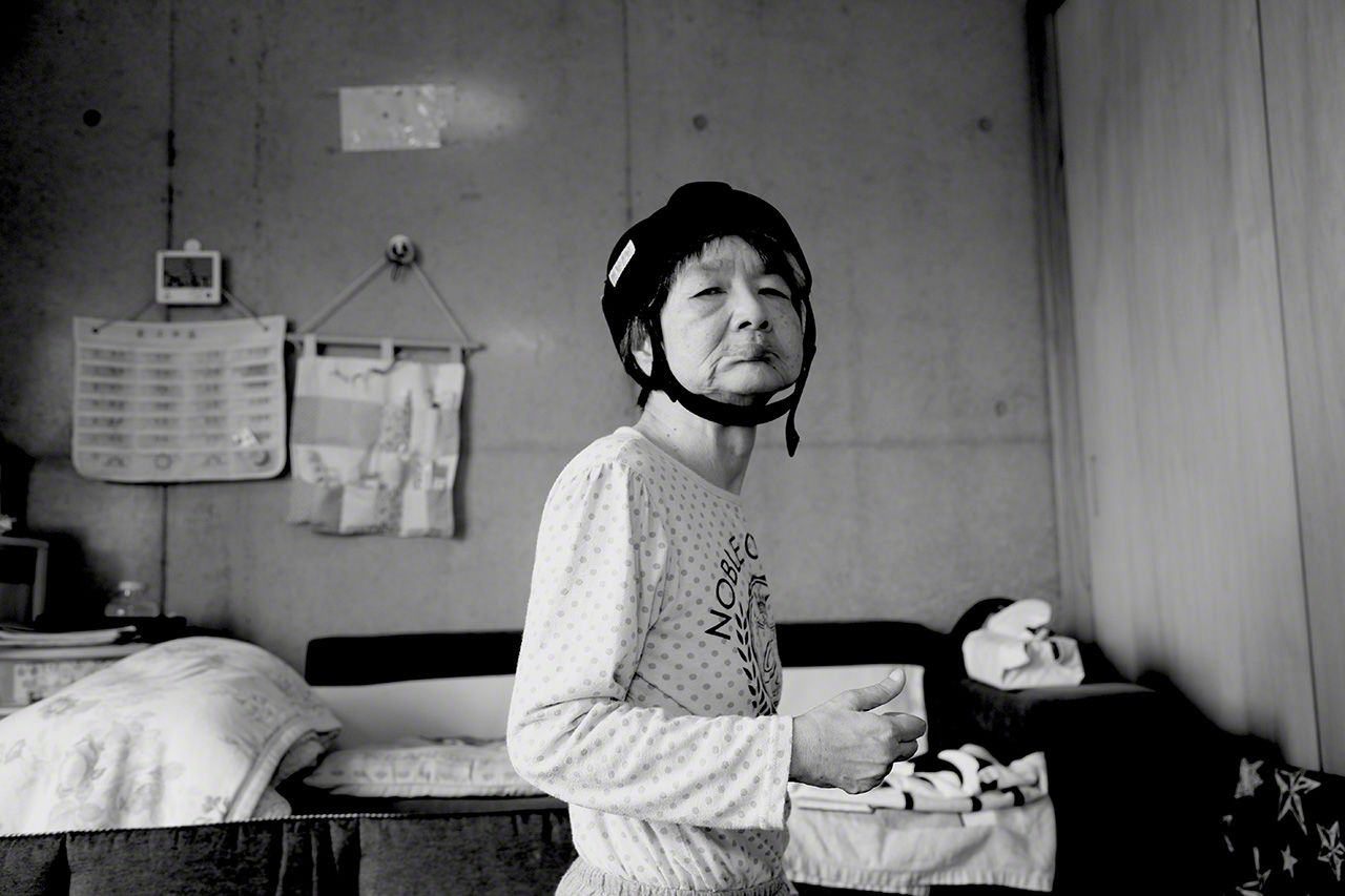 Tanaka Jitsuko in 2018. Today she resides with her elderly sister and brother-in-law and receives round-the-clock nursing care. The helmet is to protect her head from falls.