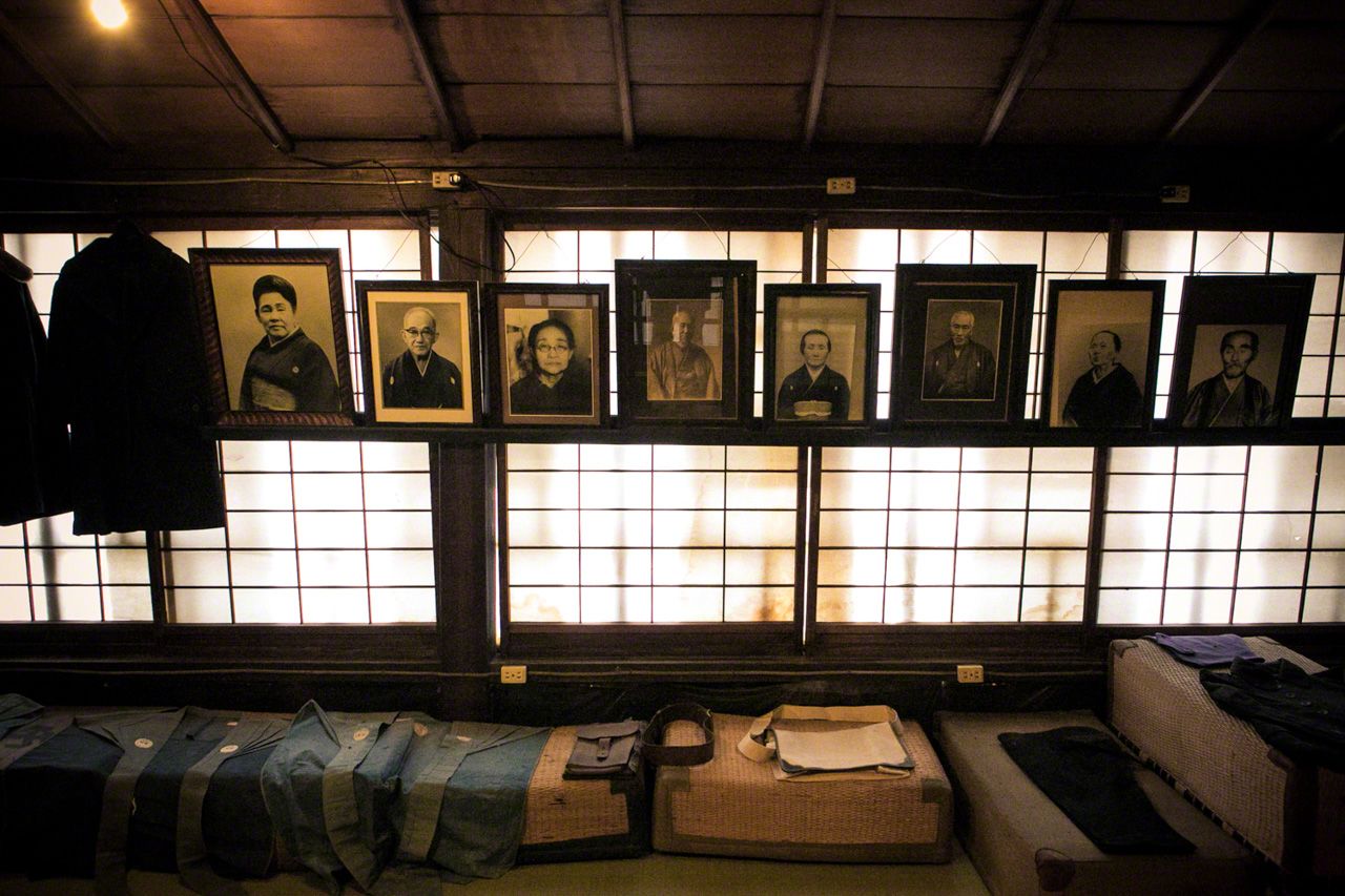 Photographs of ancestors displayed at a sake brewery established in 1856.