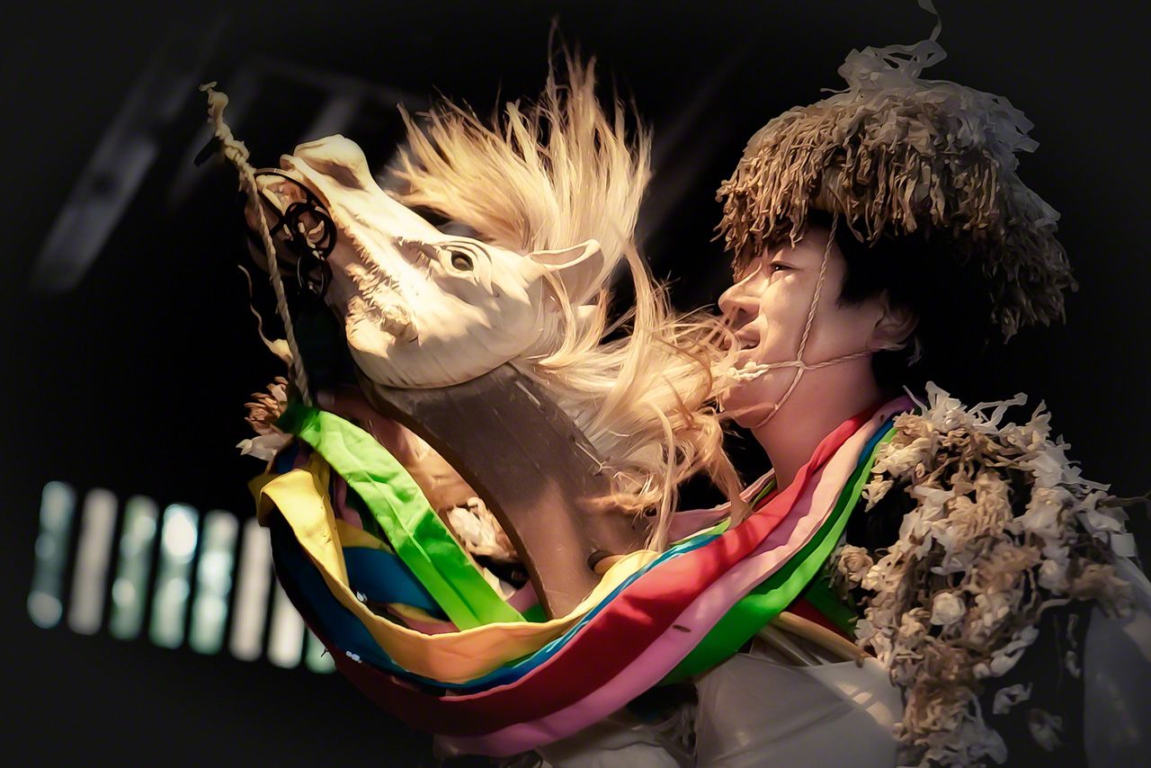 In the Komamai, two performers represent horses, beating time with their feet as they grip reins and move the animal’s heads.