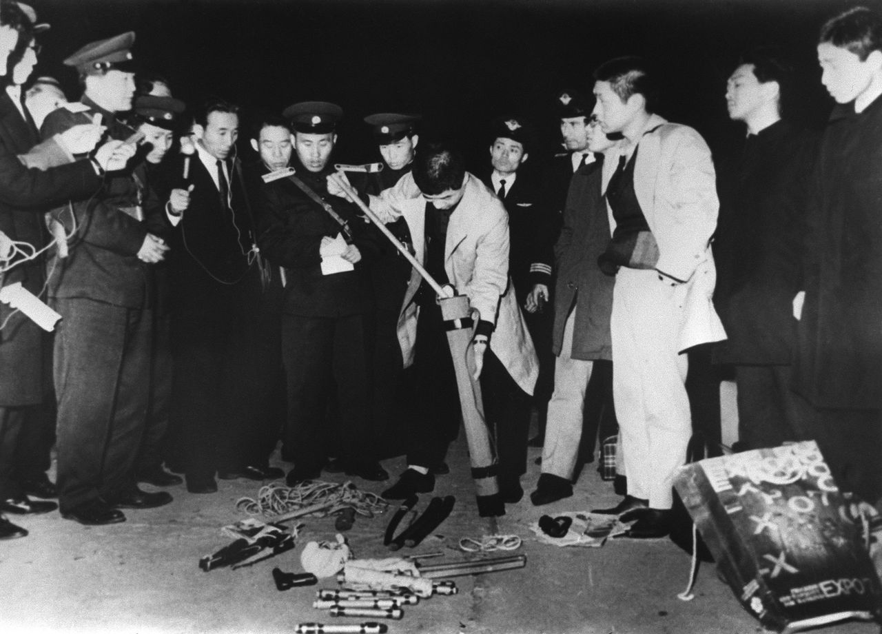 Tamiya Takamaro and other Red Army faction members are disarmed at Pyongyang Airport in North Korea on April 3, 1970, following the hijacking of Japan Airlines flight 351.