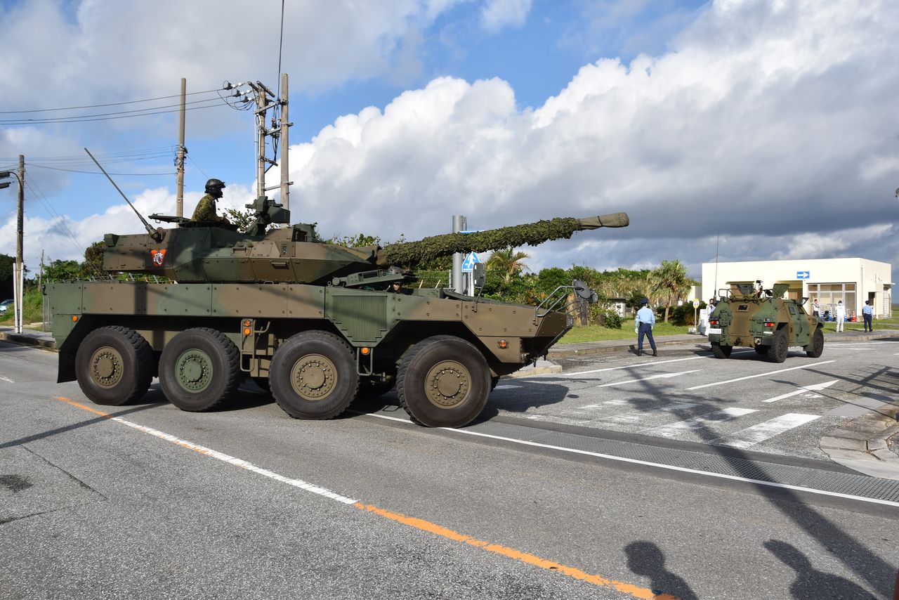 A Japanese Type 16 maneuver combat vehicle (MCV) drives along a public road on the island of Yonaguni, Okinawa Prefecture, as part of a Japan-US joint military exercise, November 18, 2023. (© Jiji)