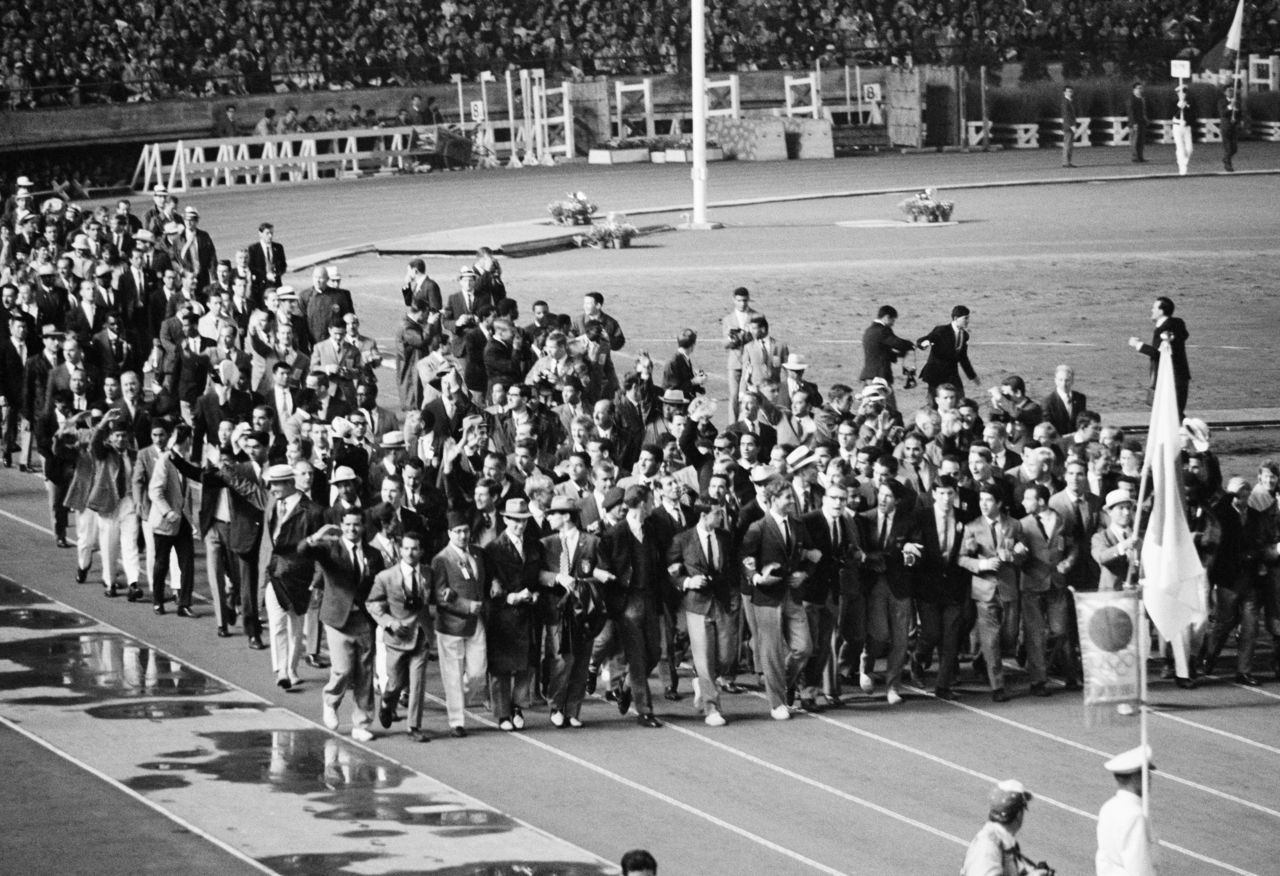 At the closing ceremony for the 1964 games, members of many national teams came together to parade arm in arm before the crowds. (© Jiji)