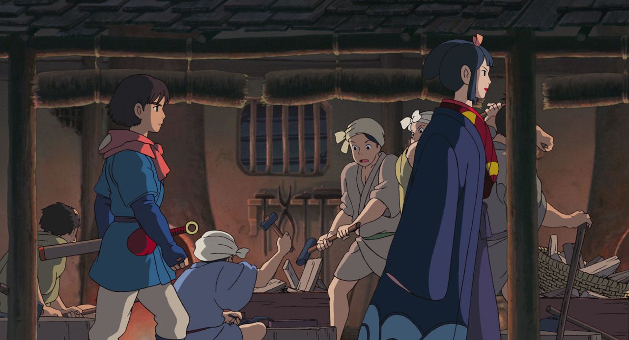 Ashitaka (left) follows Lady Eboshi through her iron foundry. (© 1997 Hayao Miyazaki/Studio Ghibli, ND)