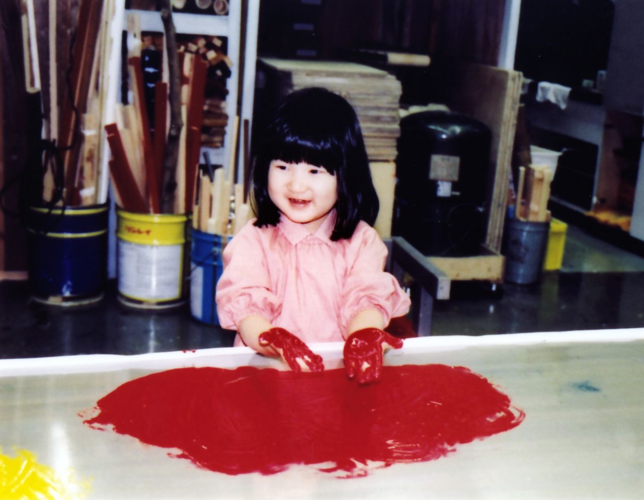 Princess Aiko gets creative with some red paint in November 2005. (Courtesy Imperial Household Agency; © Reuters)