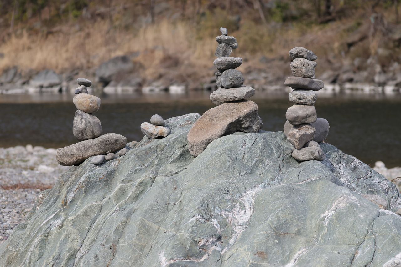 An image of the piles of stones on the sai no kawara riverbank.