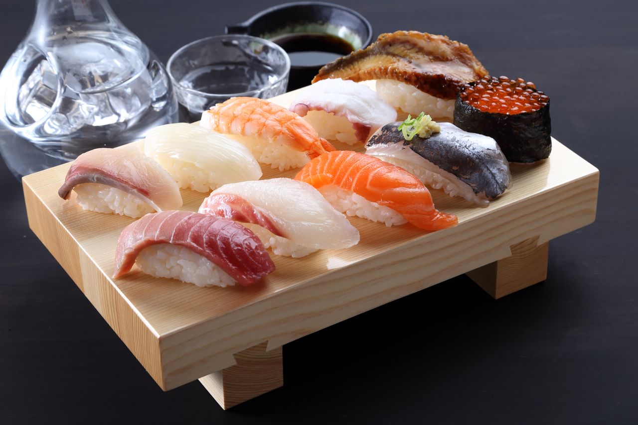 A geta board laden with sushi.