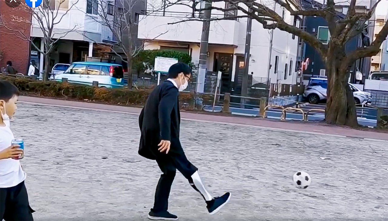 Sun plays soccer with a prosthetic he designed himself.