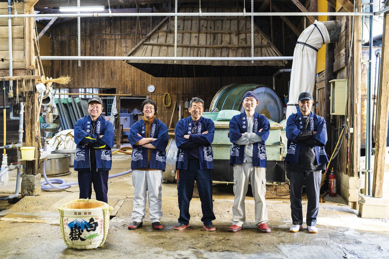 Employees at Tsushima Island’s only sake brewery, Kawachi Shuzō. President Itō Kōichirō, center, is flanked by his son Shintarō, second from right, who returned to the island after studying sake brewing at a university in Tokyo.