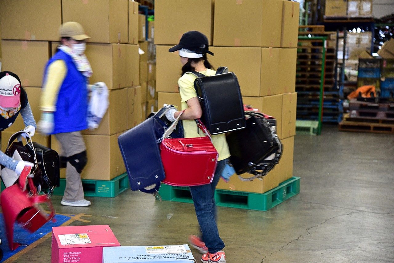Volunteers deliver another batch of randoseru bags.
