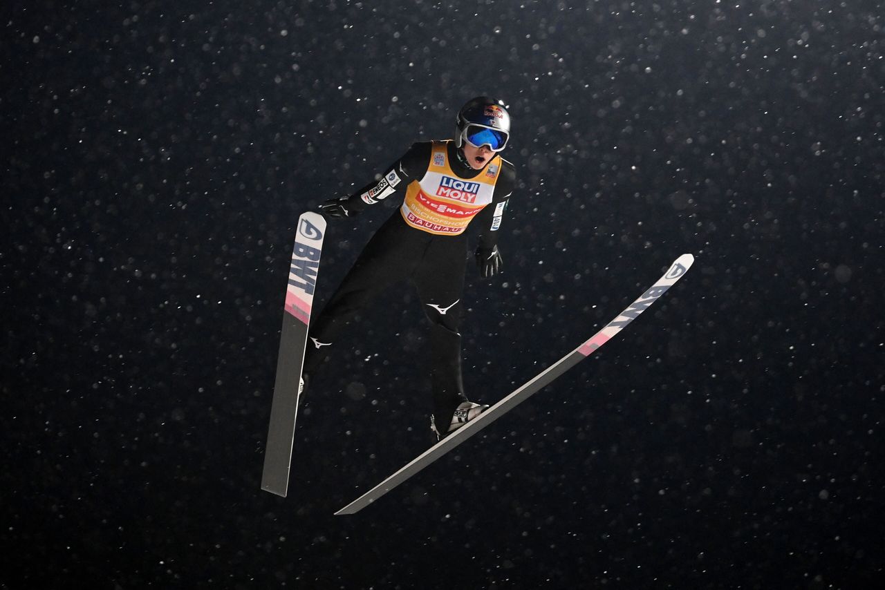 Kobayashi sails through the falling snow during the last leg of the Four Hills tournament in Bischofshofen, Austria, on January 6, 2022. (© AFP/Jiji)