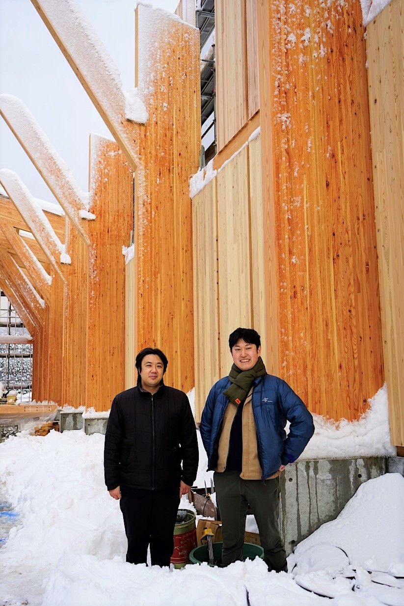 Inagaki (right) and Shimono in front of their under-construction warehouse. Both believe that the entire industry should work to continue improving Japanese whisky.