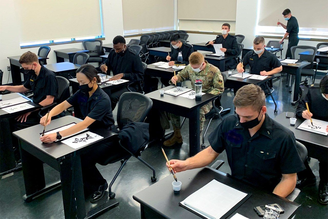 Midshipmen in the Japanese-American club practicing calligraphy.
