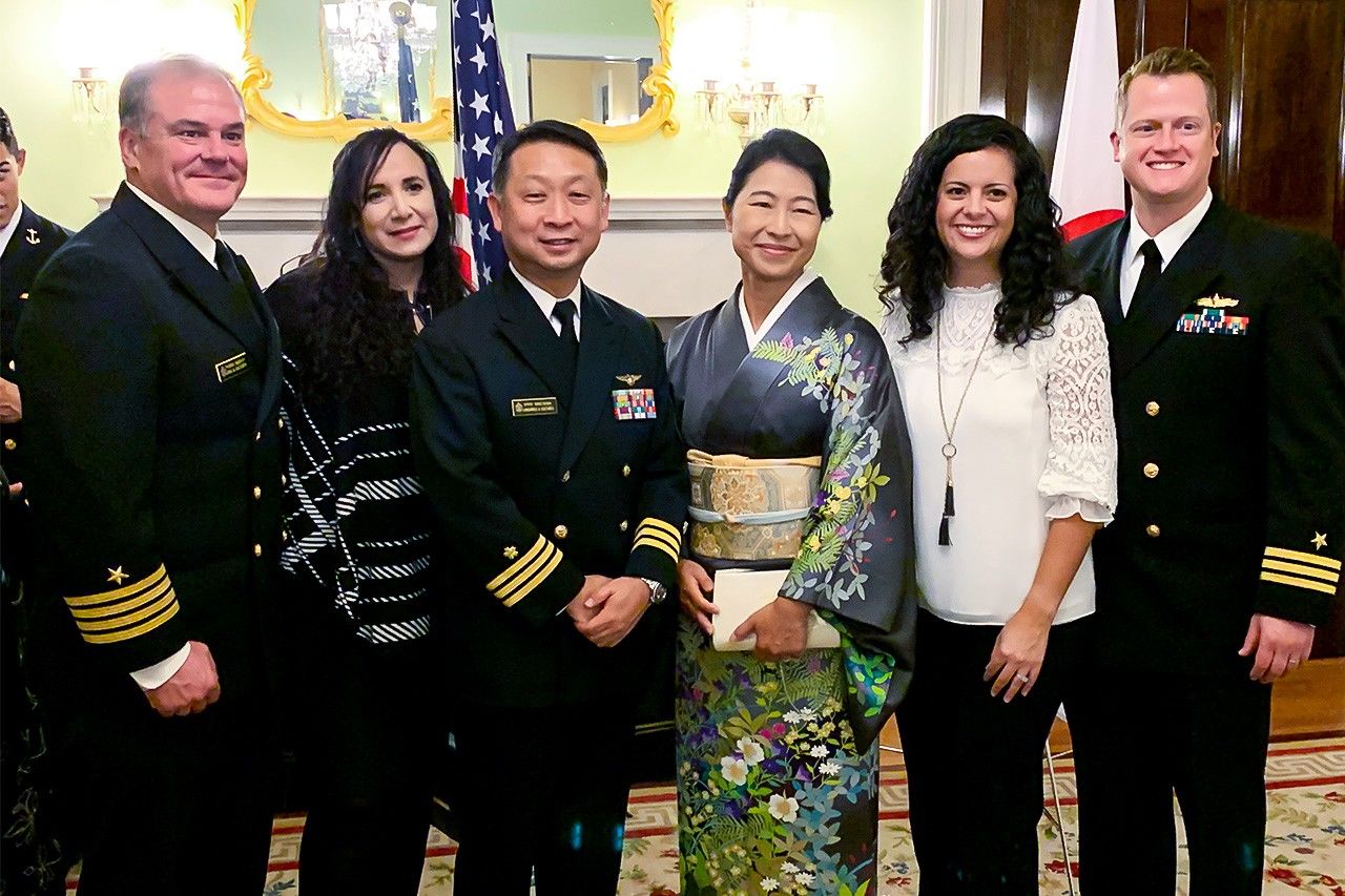 Maeyama and his wife pose with colleagues at the former official residency of the Japanese ambassador.