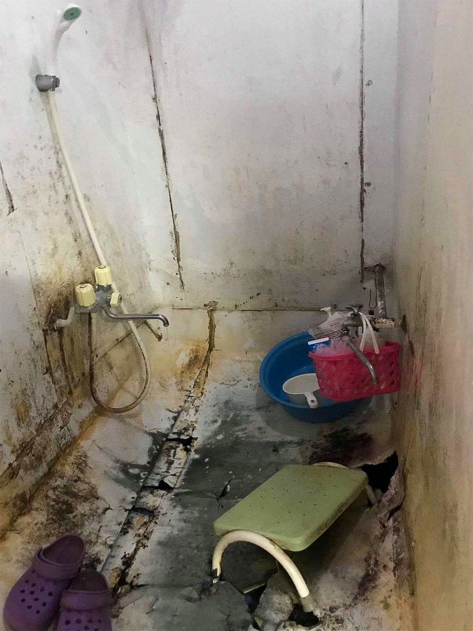 Zhen says technical trainees sometimes endure dangerous or dirty conditions, such as this squalid shower in living quarters for interns from Cambodia.