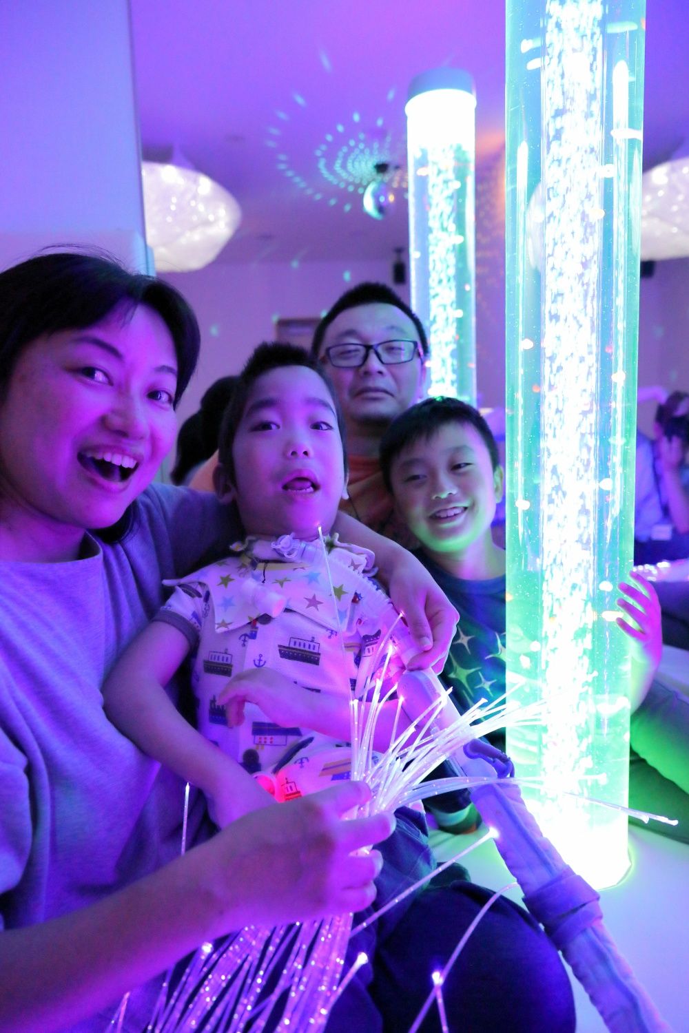 Miyazoe Shinsuke plays in the sensory room with his family. (Photo courtesy of KidsFam Foundation)