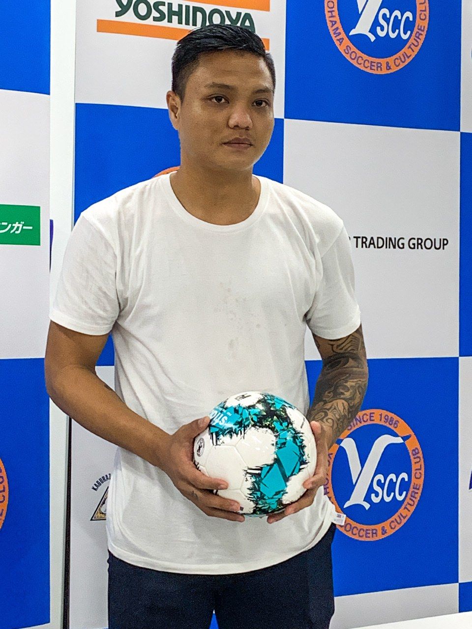 Pyae Lyan Aung talks to the press in Yokohama in October 2021 after failing to make the roster for a game.