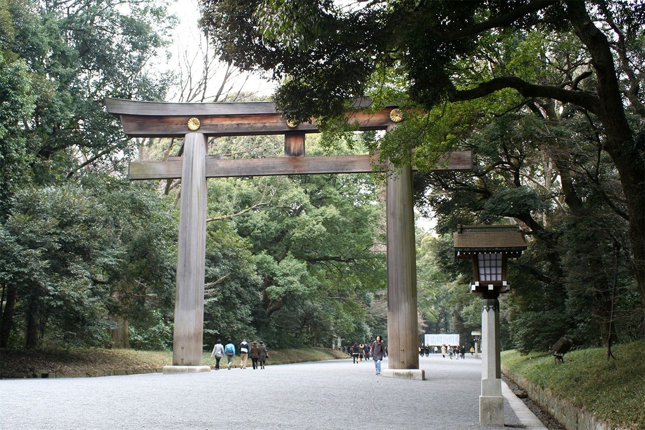 A century later, the same torii is now shrouded by trees.