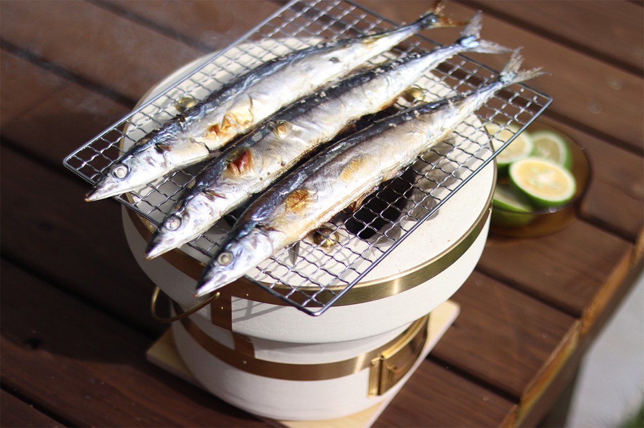 Sanma, a traditional autumn staple, grill over coals.