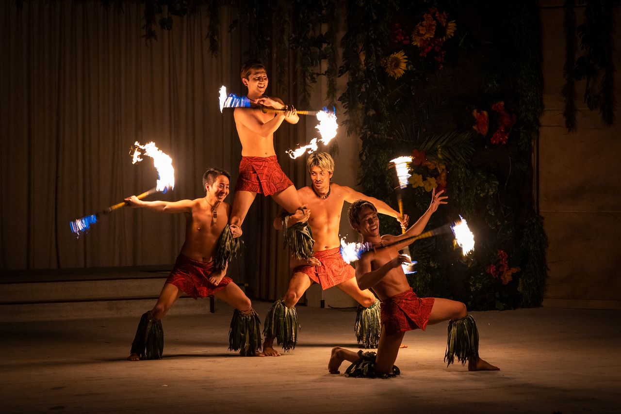 Male dancers perform the Samoan fire knife dance.