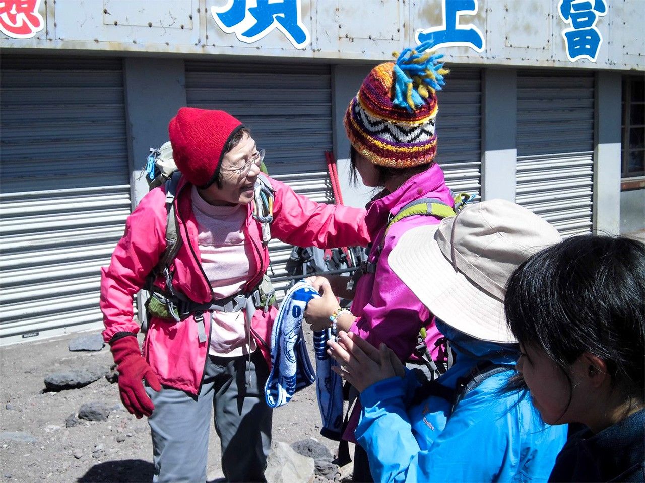 Tabei Junko celebrates in 2013 with high schoolers at Mount Fuji’s summit. (Courtesy of the Junko Tabei Fund)