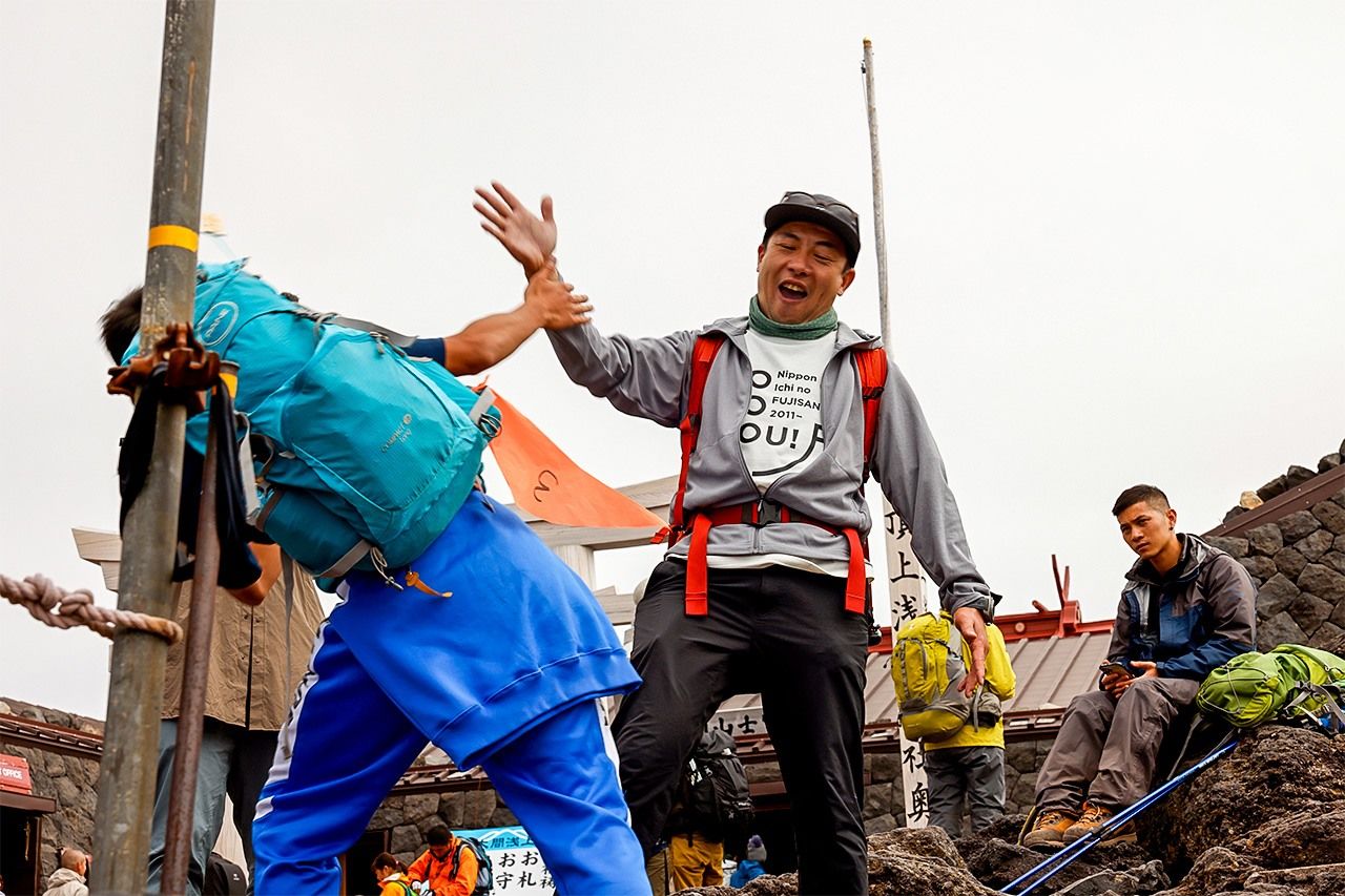 Shin’ya and one of the students “high five” upon reaching the summit. (Courtesy of the Junko Tabei Fund)