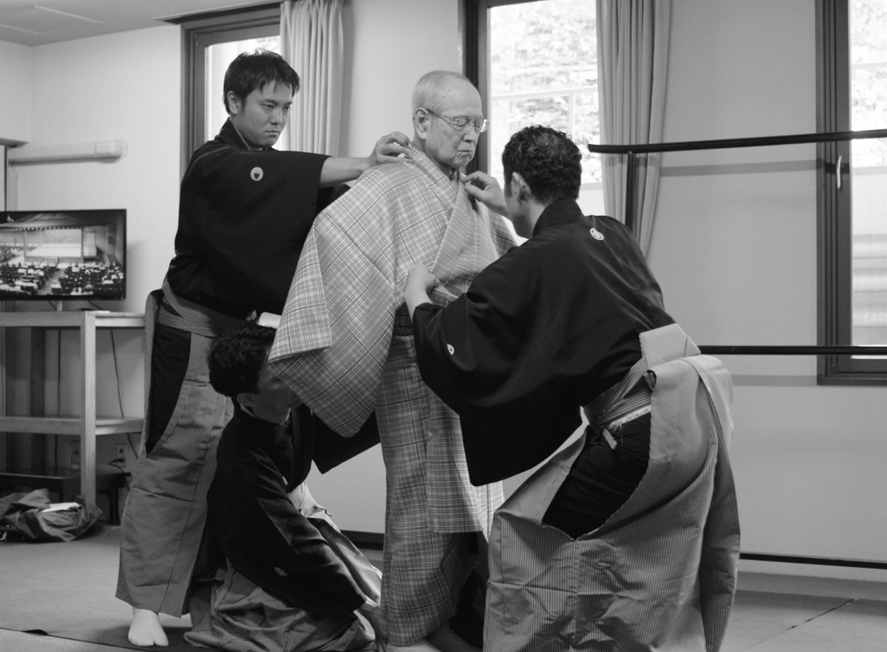 Getting dressed in a kyōgen costume is a task requiring three assistants. (© Mansaku no Kai)