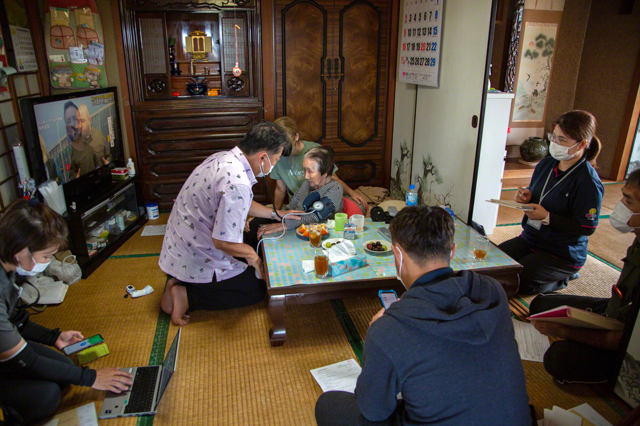 With home visitations, staff and family members cooperate to support the patient. (© Ōnishi Naruaki)