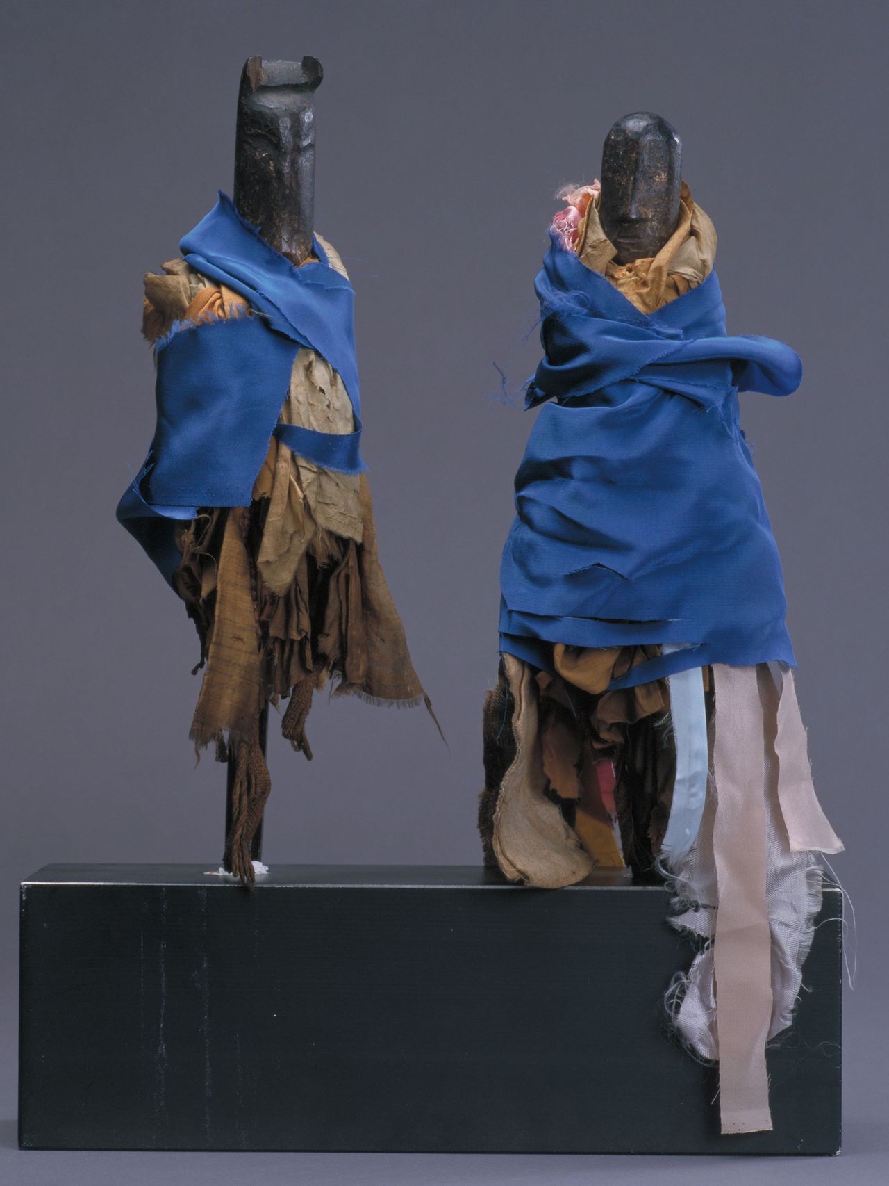 In people’s homes, Oshirasama is typically represented by two dolls made of mulberry wood about 30 centimeters high. One is carved with a horse’s head and one with that of a girl. They would be taken out of a box during festivals and draped with cloth garments before worship. The photograph shows a pair of Oshirasama dolls worshipped as a silk culture deity at a residence in Rikuzentakata, Iwate. (© Iwate Prefectural Museum)