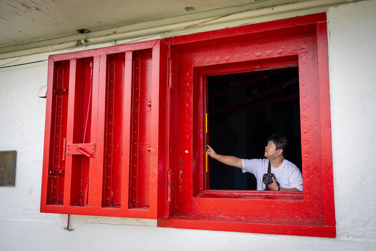 Ishii Hiroshi shows a blast window still in place at Xavier High School, on the main island of Weno. (© Julian Ryall)