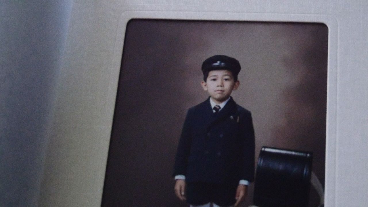 A young Kasai Jun in his elementary school uniform. His love of professional wrestling started when he was a child. (© 2021 Jun Kasai Movie Project)
