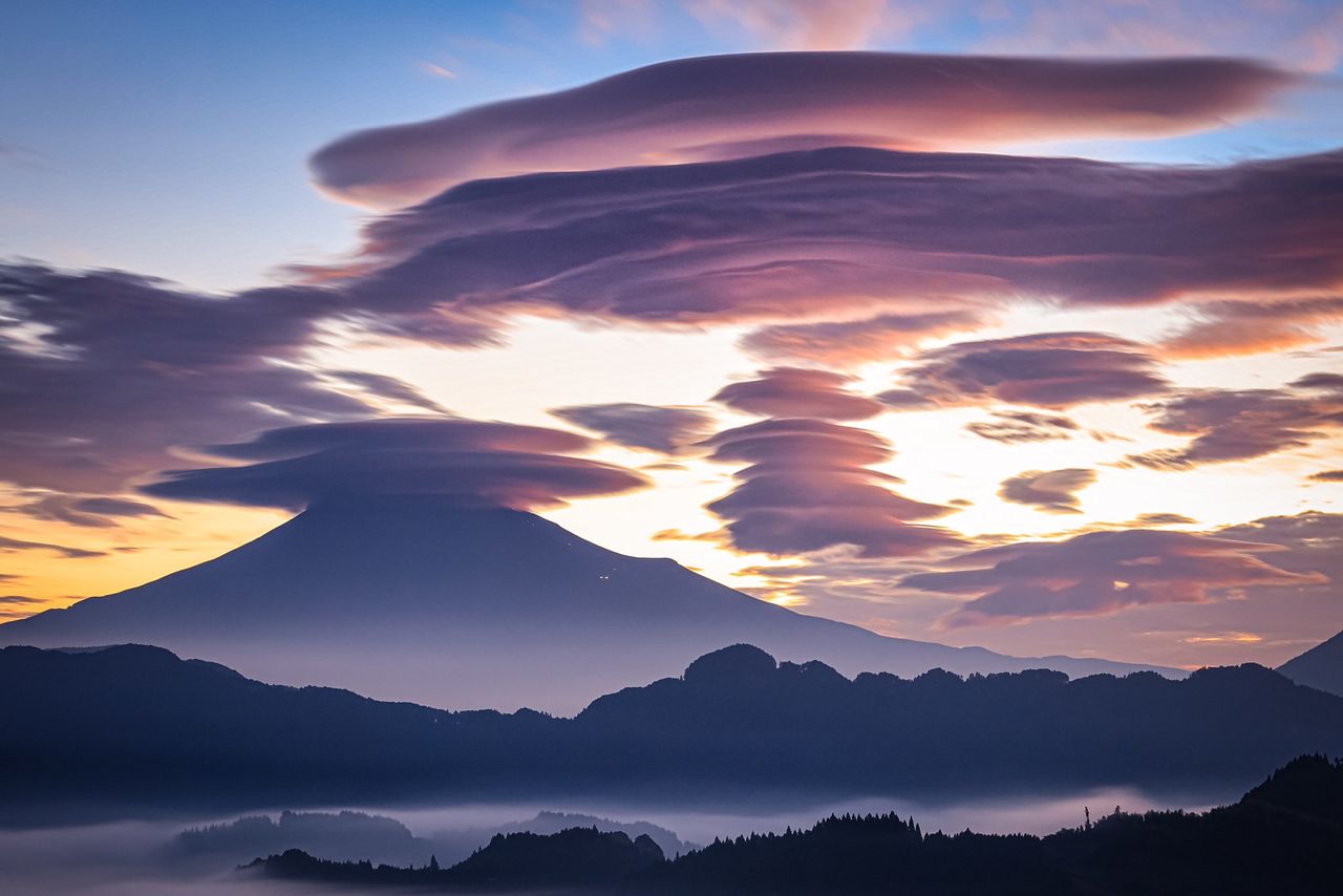 He posted this photo with the comment “It looks just like a fortress.” On the right is a series of lenticular clouds.